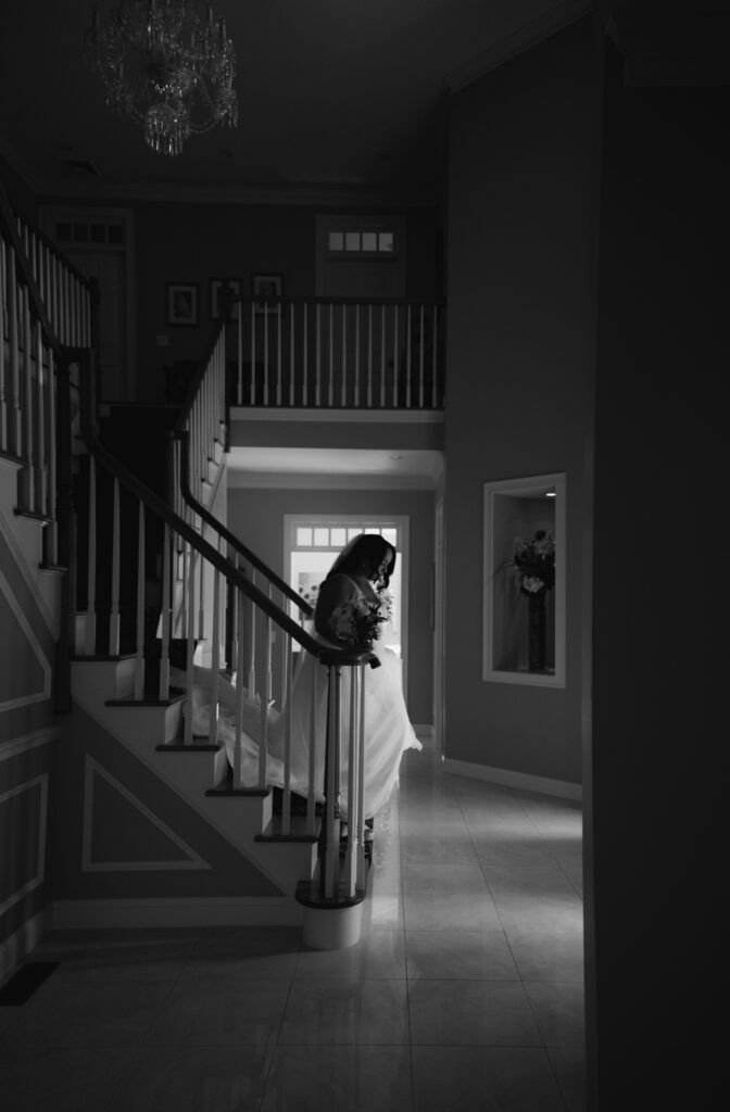 Slow morning getting ready in new hampshire mountain airbnb. Bride walking down steps in airbnb before her elopement in the white mountains.