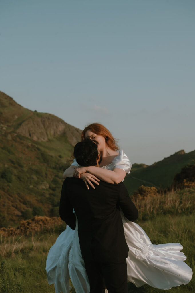 Bride and groom spinning around during their edinburgh elopement