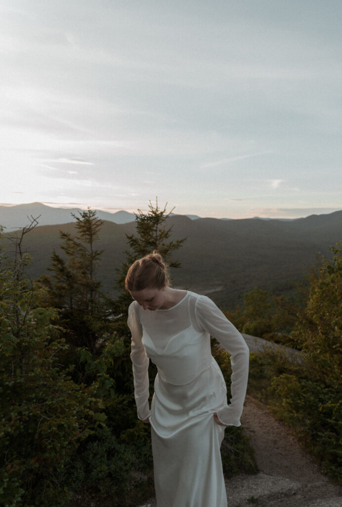 Bride getting ready in her wedding dress for her first look during her sunrise white mountain elopement