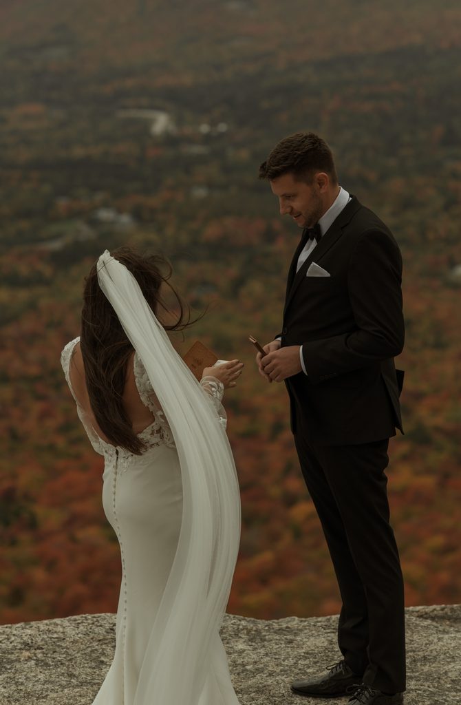 Couple exchanging vows during an intimate White Mountains elopement surrounded by peak New Hampshire fall foliage