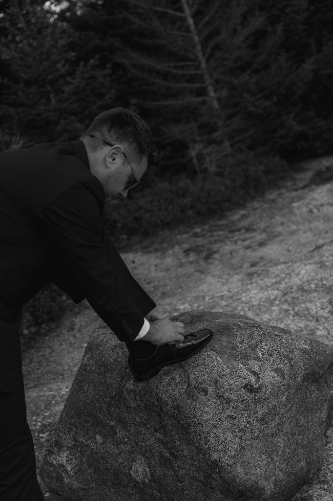 Couple relaxing and enjoying a picnic together before hiking to their White Mountains elopement ceremony