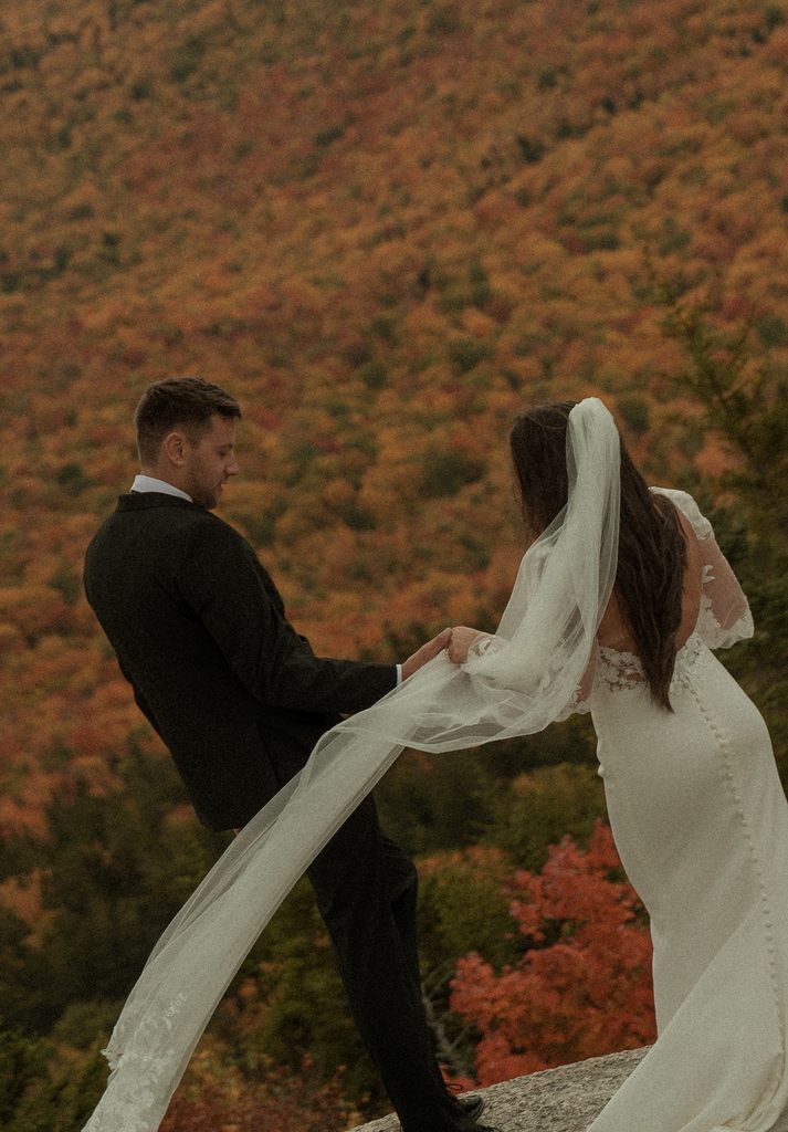 New Hampshire elopement photographer documenting a couple's adventurous mountain wedding during fall foliage