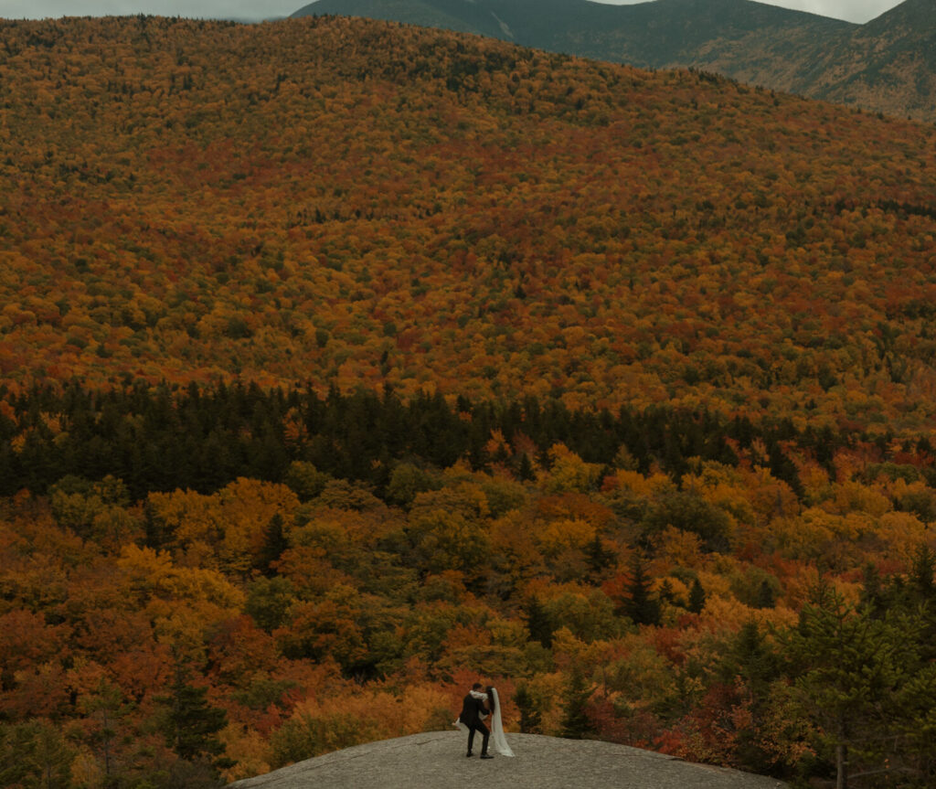 White Mountains elopement in New Hampshire during peak fall foliage with vibrant red, orange, and yellow mountain views
